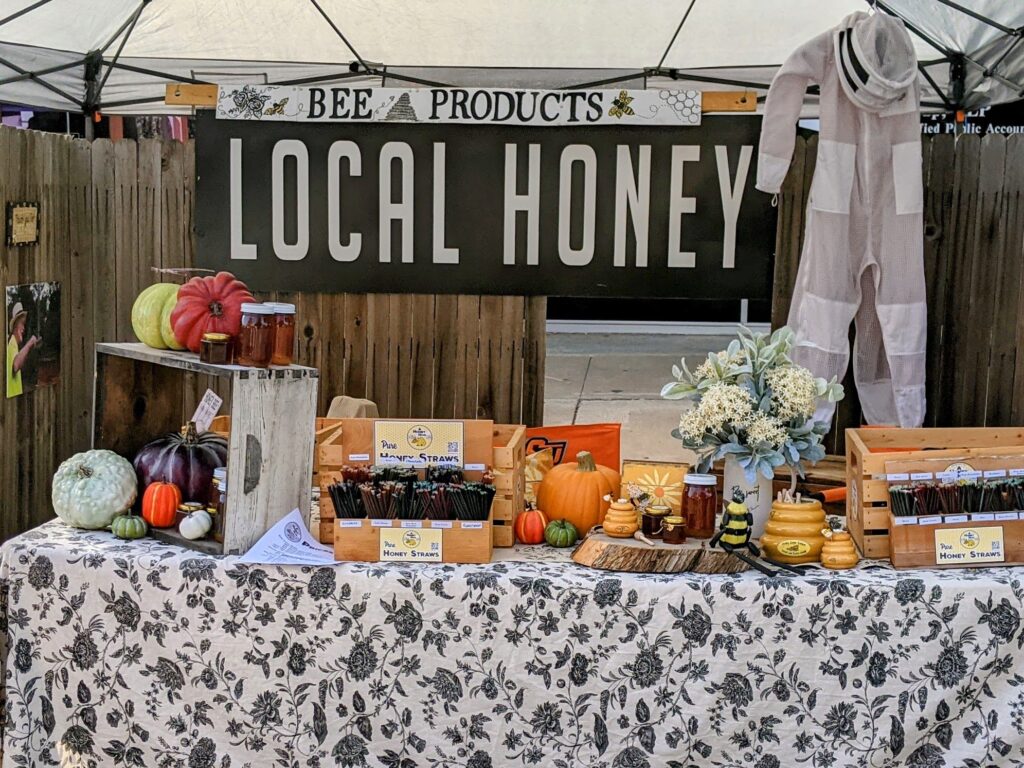 A quick view of our honey and bee products in our Local Honey booth with Fall decorations.