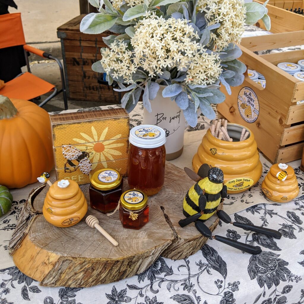 Close-up of our honey and bee products arranged on a table with Fall decorations.