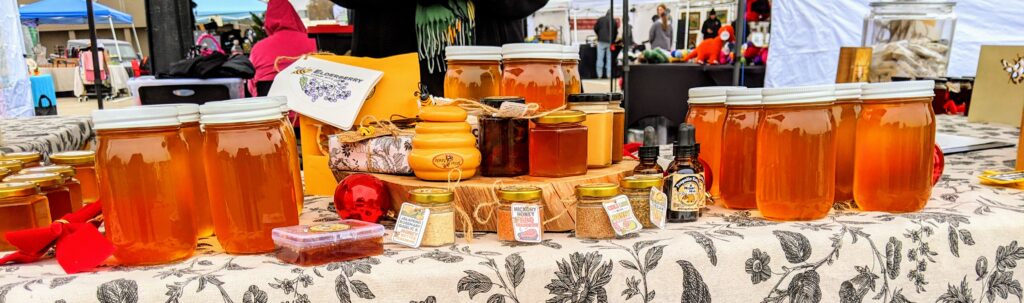 A Honey Hive - a spread of local raw honey jars and other great bee and honey products such as creamed honeys, infused honeys, and honey-based seasonings.