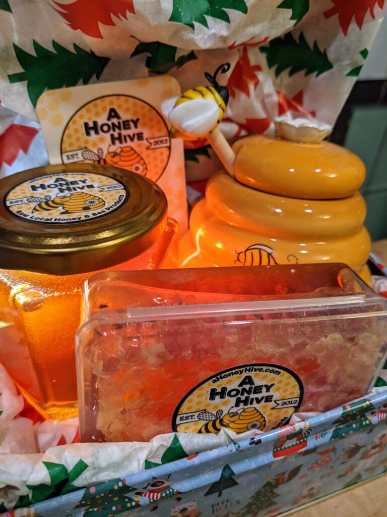 A Honey Hive Bee honey, honey dipper set, and Honey Comb close up!